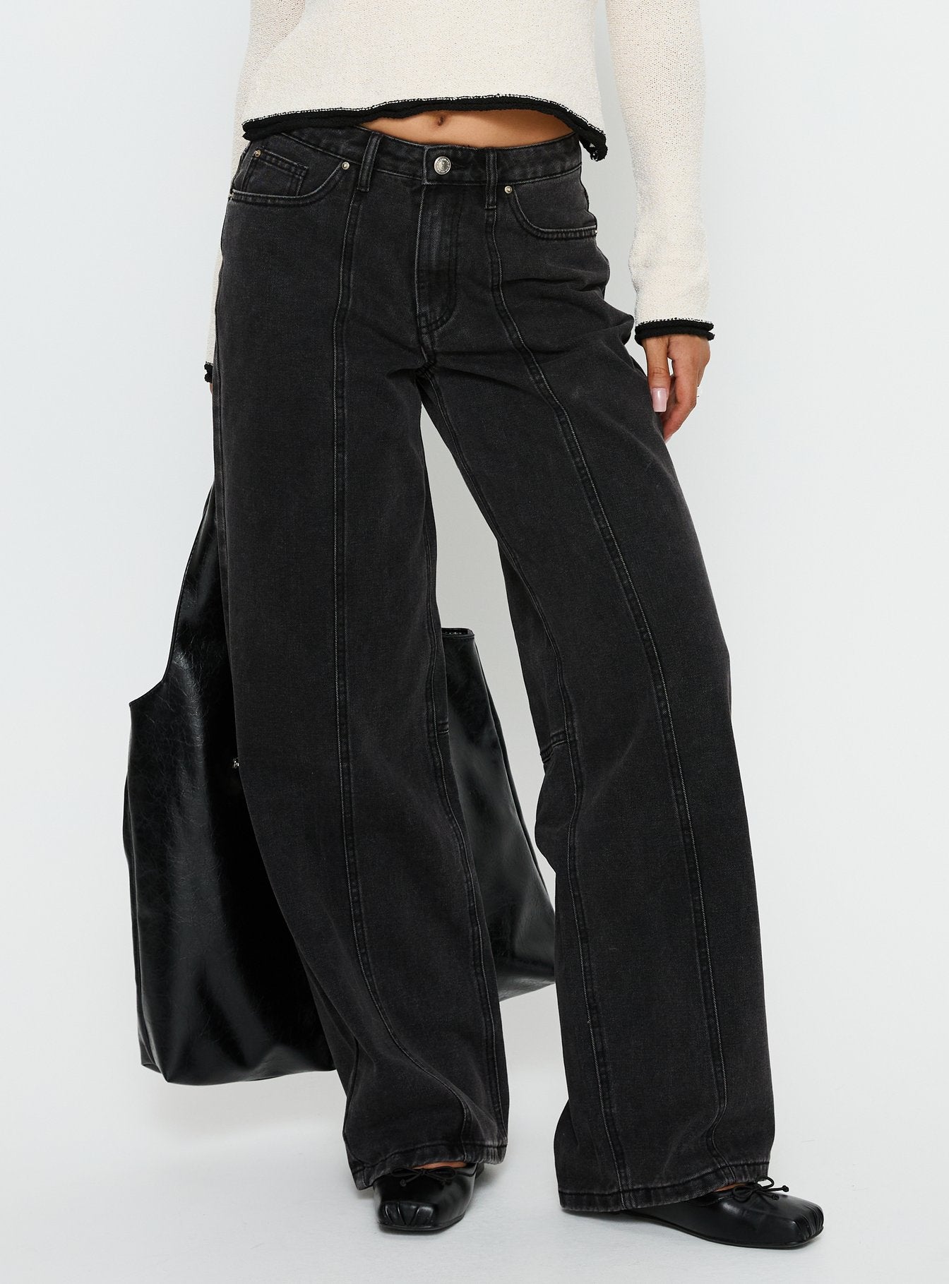 side view of model wearing Princess Polly Lando Low Rise Straight Leg Jeans Washed Black Low Rise Jeans 