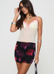   side view of model wearing Princess Polly Kennith Mini Skirt Black / Red Floral 