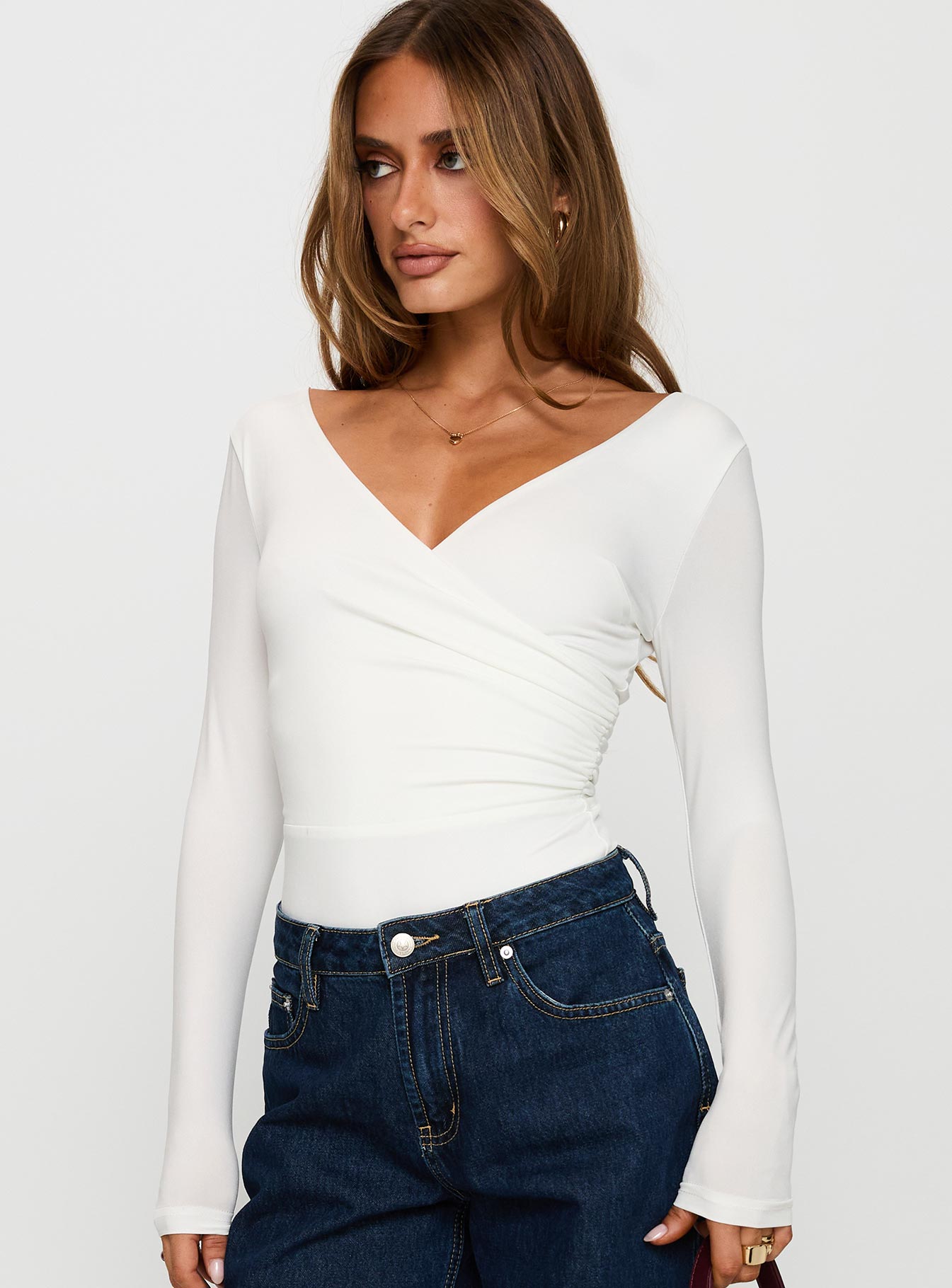 side view of model wearing Princess Polly Right Here Cross Detail Bodysuit White Long Sleeve Tops 