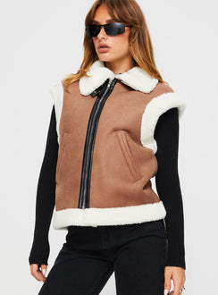 Shearling vest  Classic collar, twin hip pockets, shearling detail at shoulder and hem, faux leather detail and strap fastening at neck, silver-toned hardware, zip fastening at front 