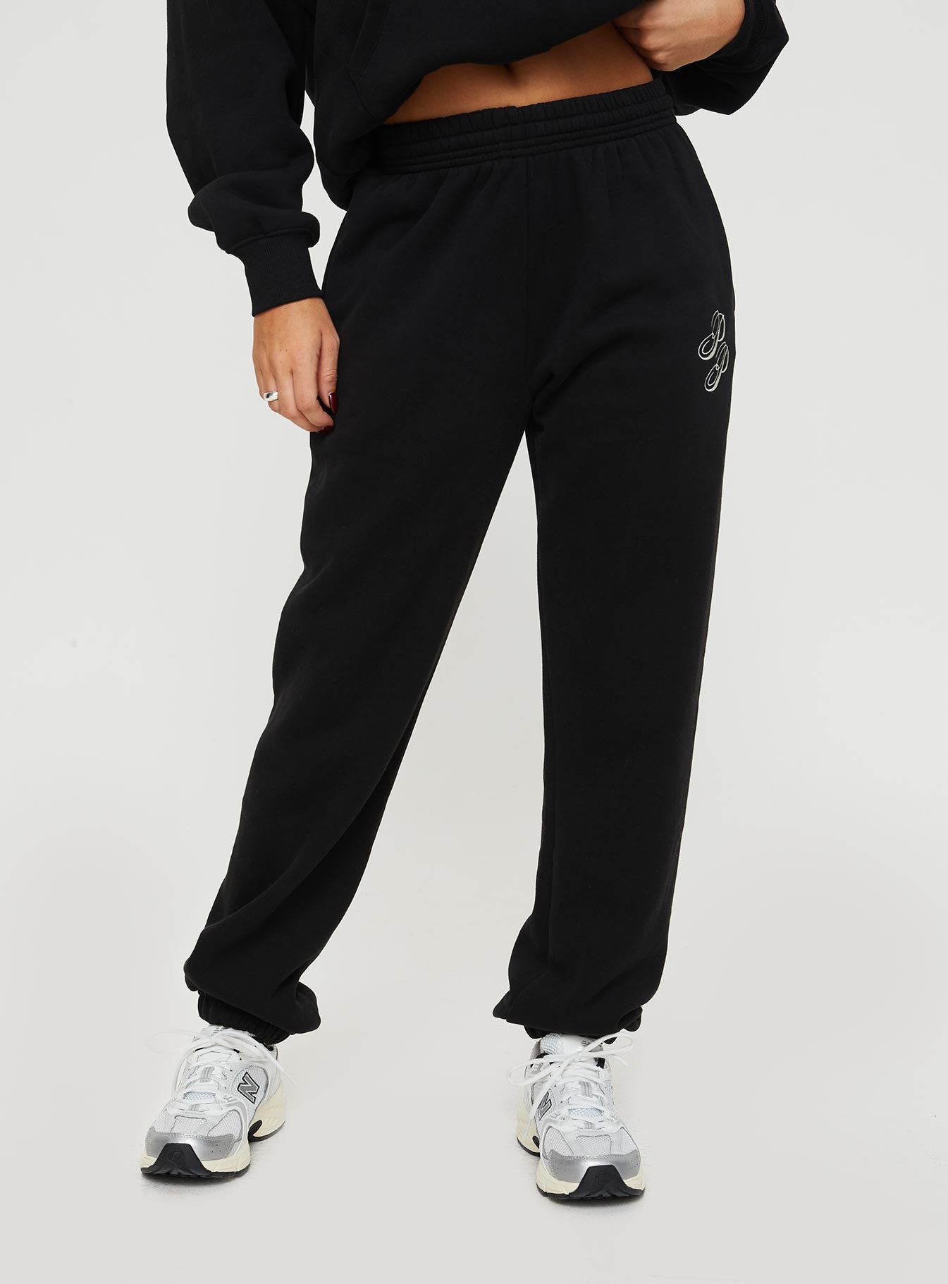 front view of model wearing Princess Polly Princess Polly Track Pants Script Black / Ivory High Waisted Pants 