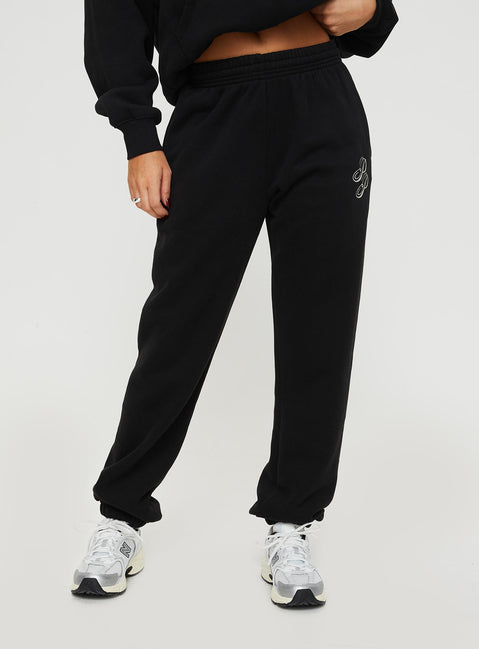 front view of model wearing Princess Polly Princess Polly Track Pants Script Black / Ivory High Waisted Pants 