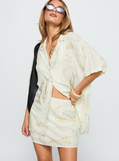   side view of model wearing Princess Polly Caraliia Mini Skirt Cream Mini Skirts 