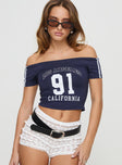 front view of model wearing Princess Polly Serendipia Off The Shoulder Graphic Top Navy Short Sleeves straight 