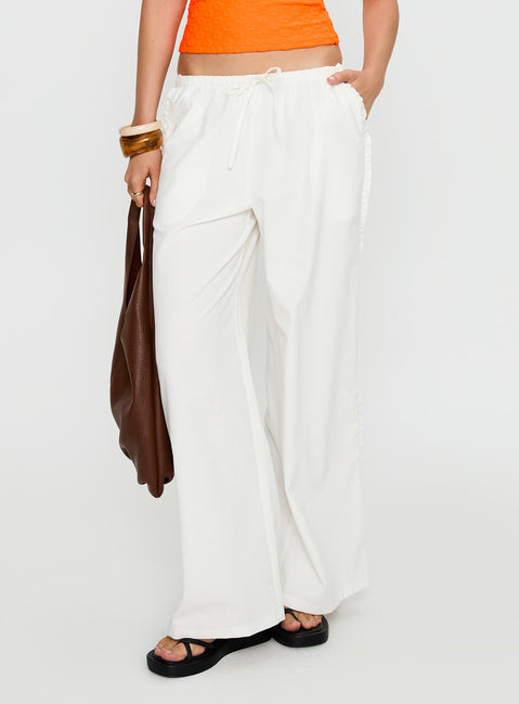 side view of model wearing Princess Polly Destinee Frill Pant White Low Rise Pants 