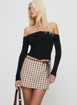 side view of model wearing Princess Polly Korren Low Rise Skort Plaid Tall 