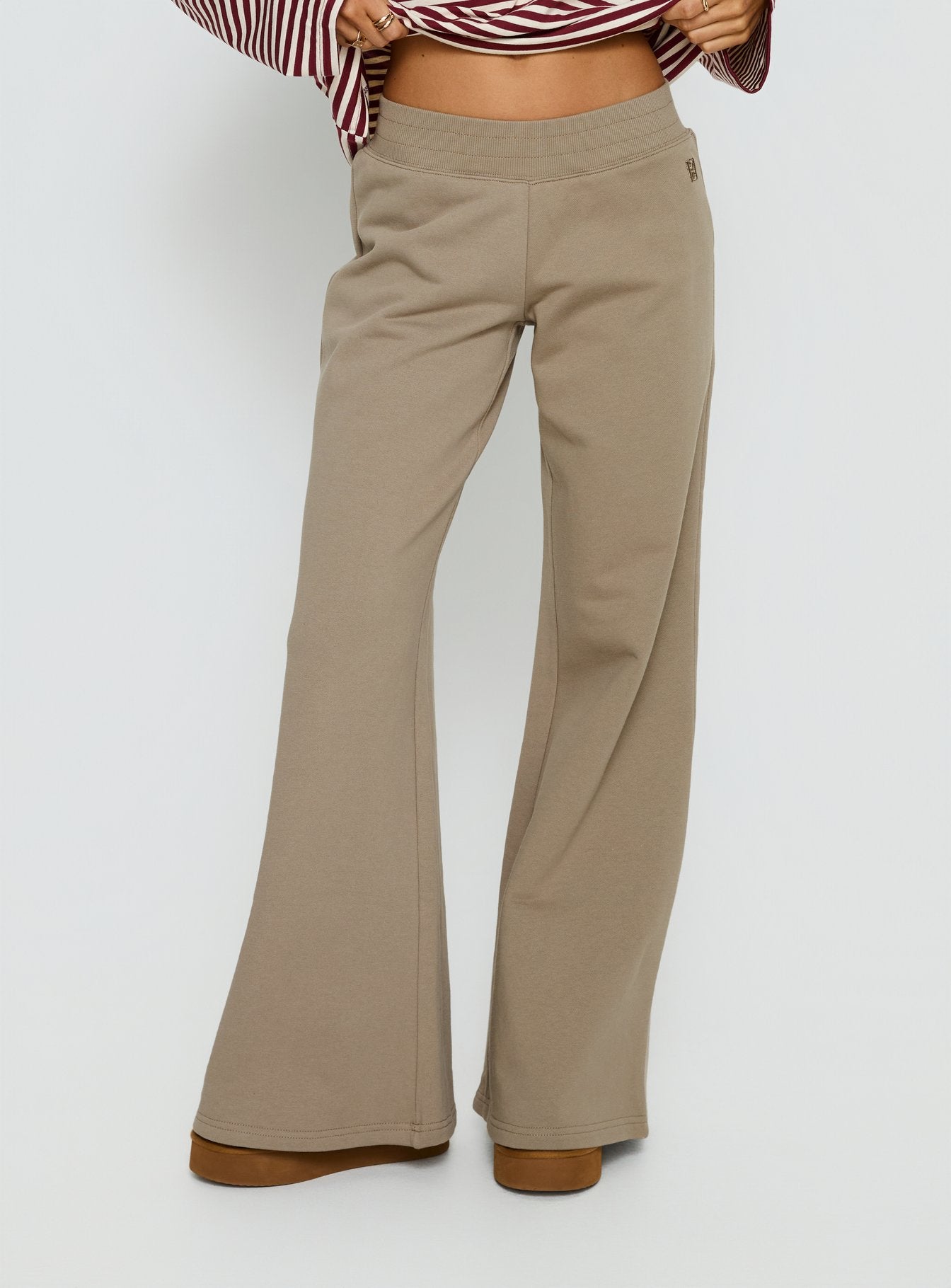 side view of model wearing Princess Polly Summits Flared Track Pants Latte Mid Rise Pants 