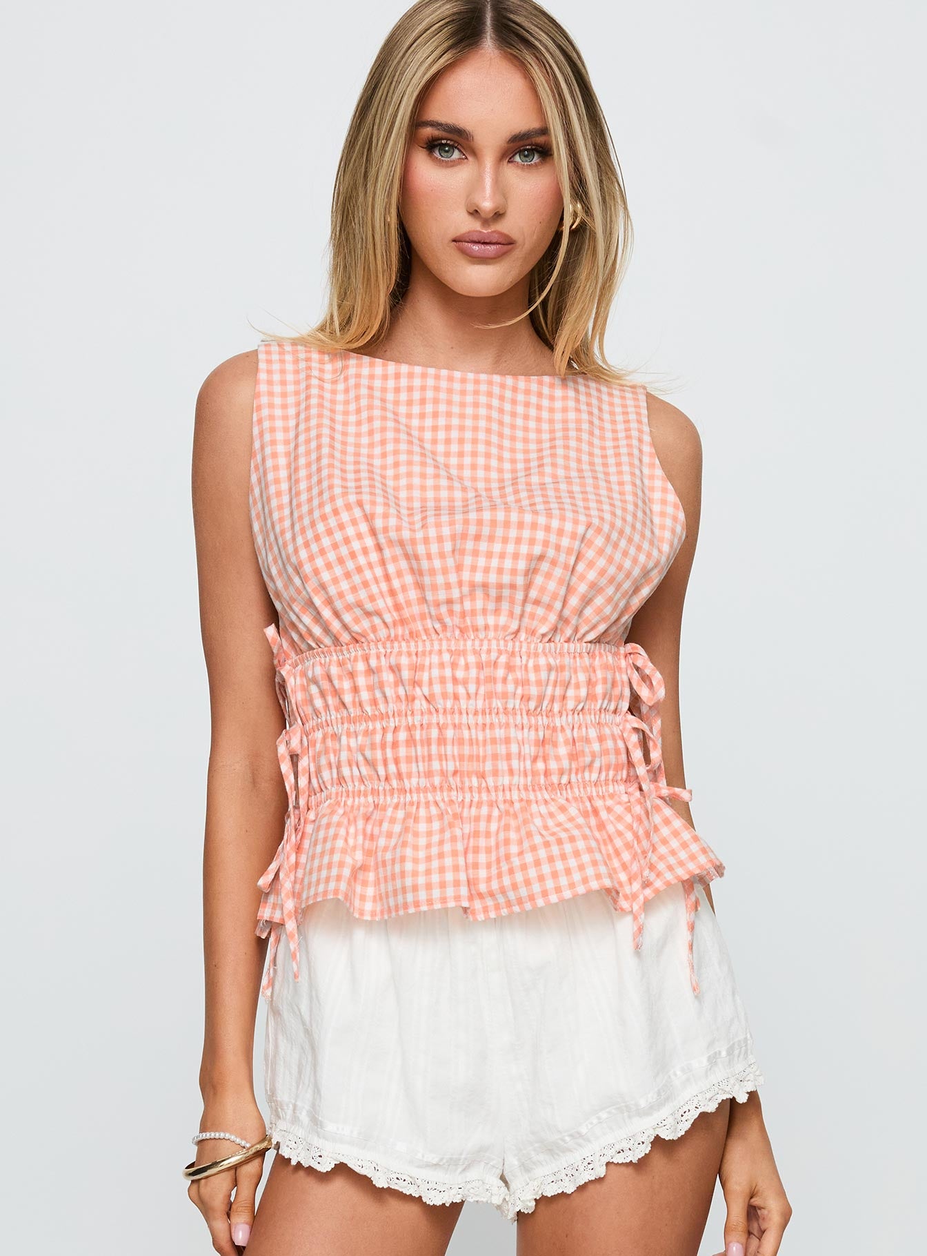 front view of model wearing Princess Polly Antiqued Tie Side Top Orange Check Sleeveless Boat Neck 