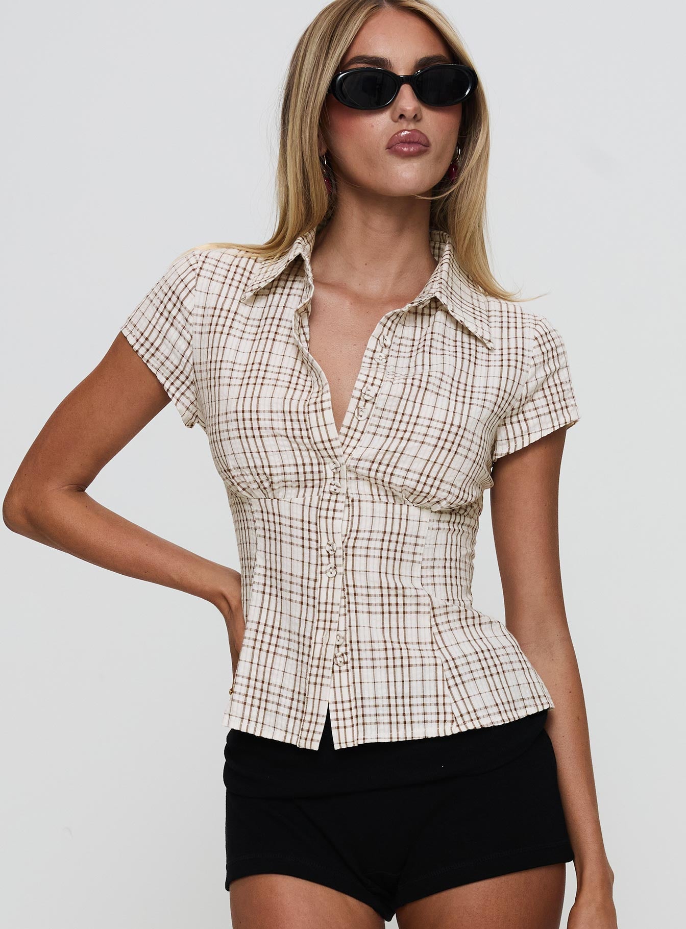 front view of model wearing Princess Polly Cottesloe Blouse Top Brown Check Short Sleeves V-Neck 