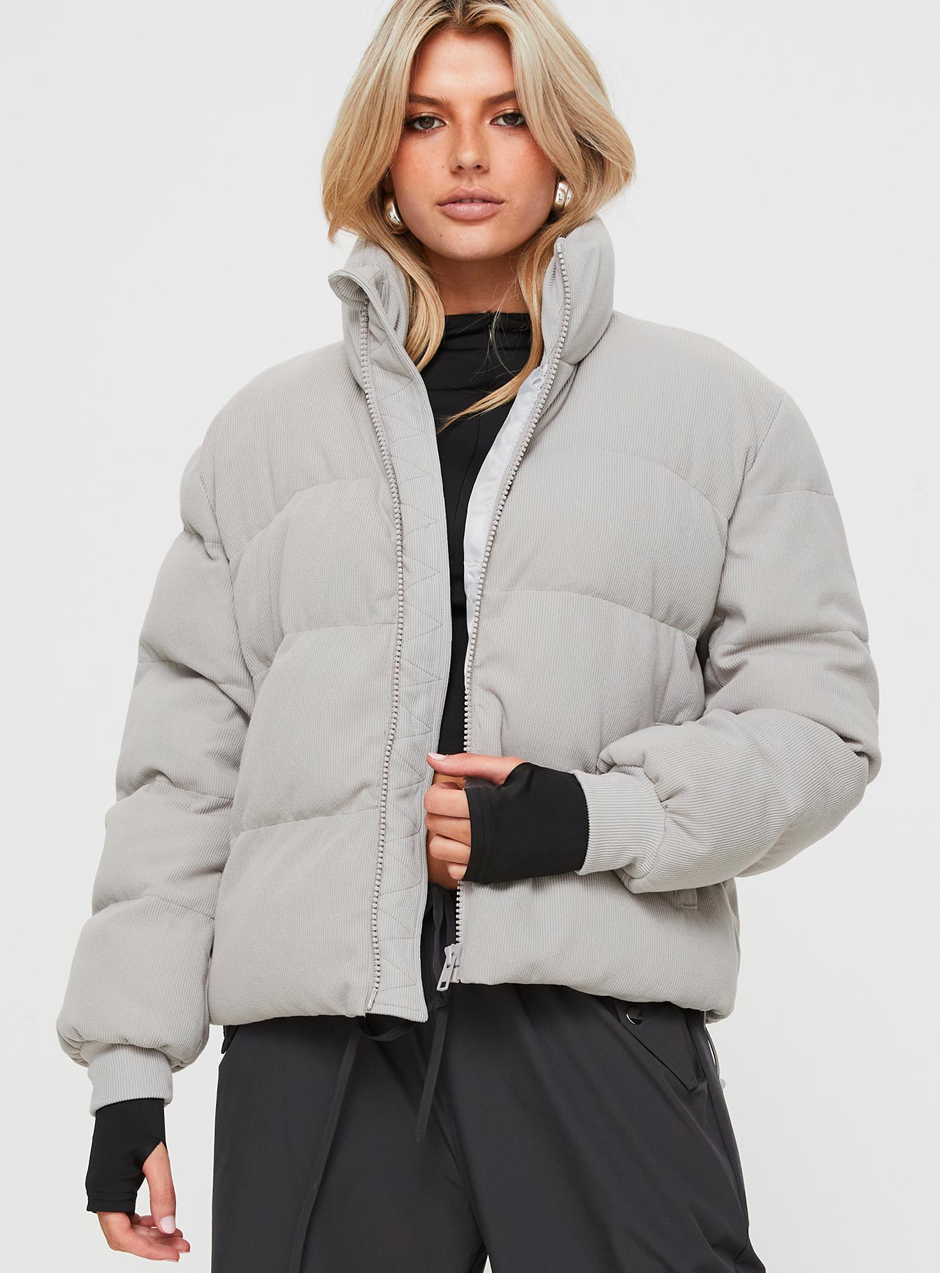Ribbed puffer jacket High neckline, twin hip pockets, zip fastening down front, drawstring waist, elasticated cuffs