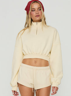 Showcasing the Astridd 3/4 Zip Cropped Jumper in Cream womens-jumpers with short length detail view of model wearing Princess Polly
