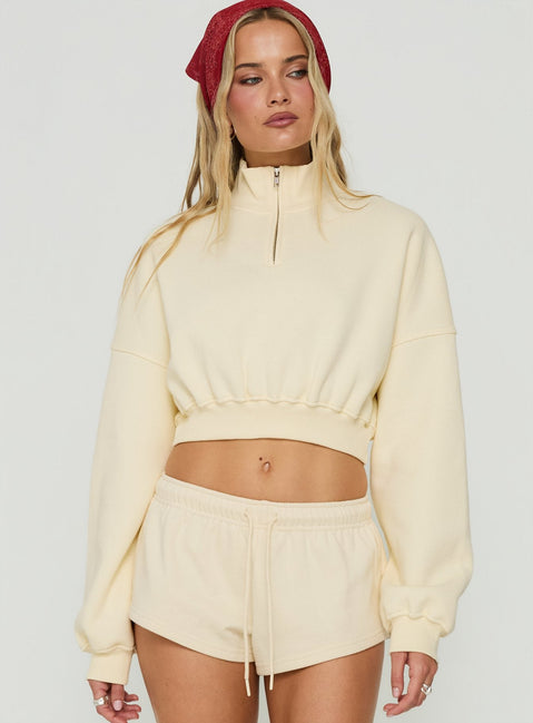 Showcasing the Astridd 3/4 Zip Cropped Jumper in Cream womens-jumpers with short length detail view of model wearing Princess Polly