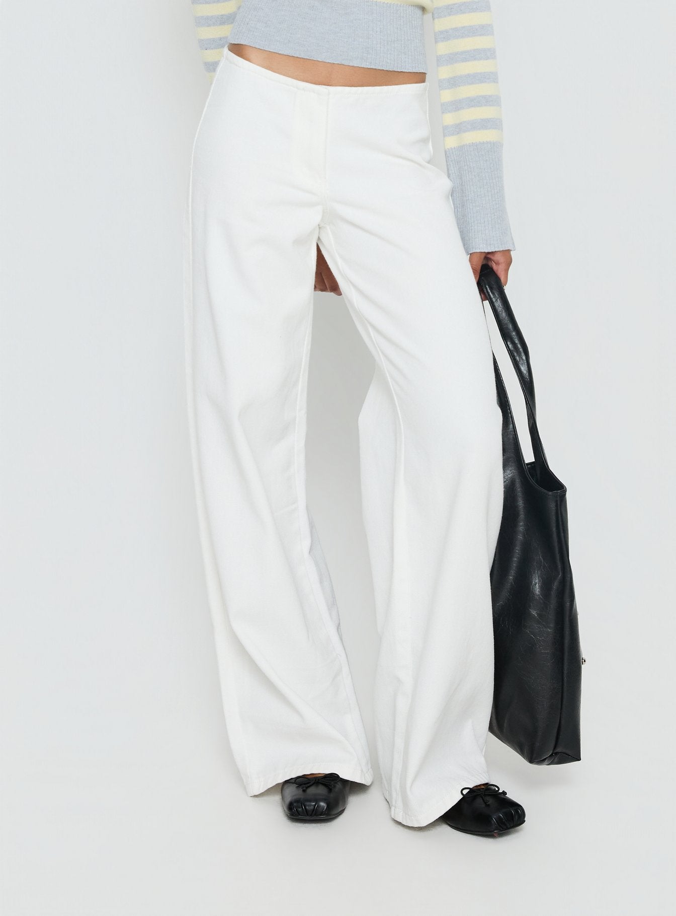 back view of model wearing Princess Polly Hereos Mid Rise Baggy Leg Jeans White Mid Rise Jeans 