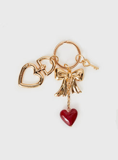 Gold toned keyring with three removable charms