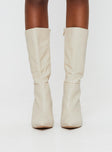 Cream Knee-high boots Faux leather material, zip fastening at inside, pointed toe, stiletto heel