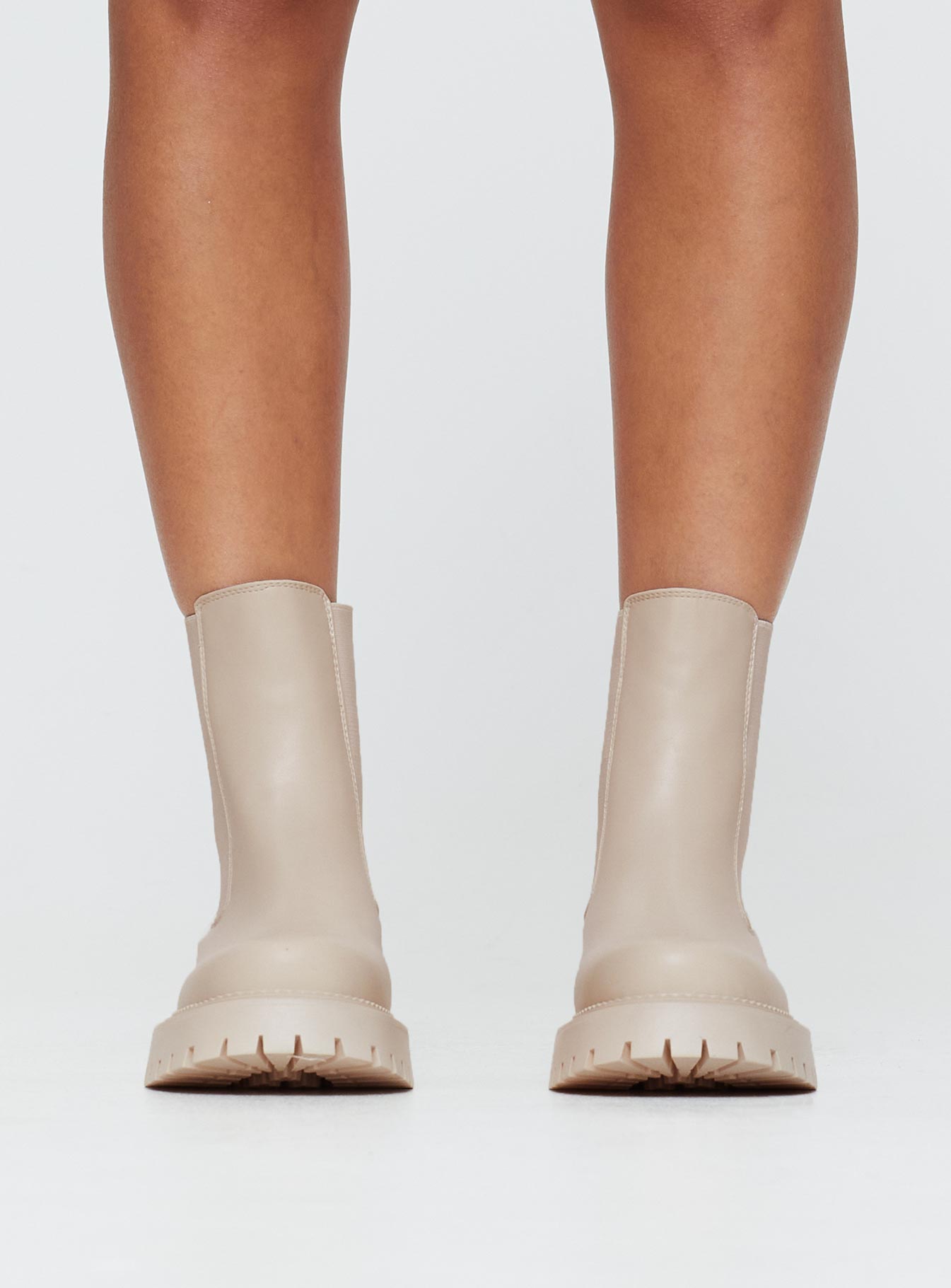 Faux leather boots Rounded toe, treaded sole, pull tab at back, passed footbed