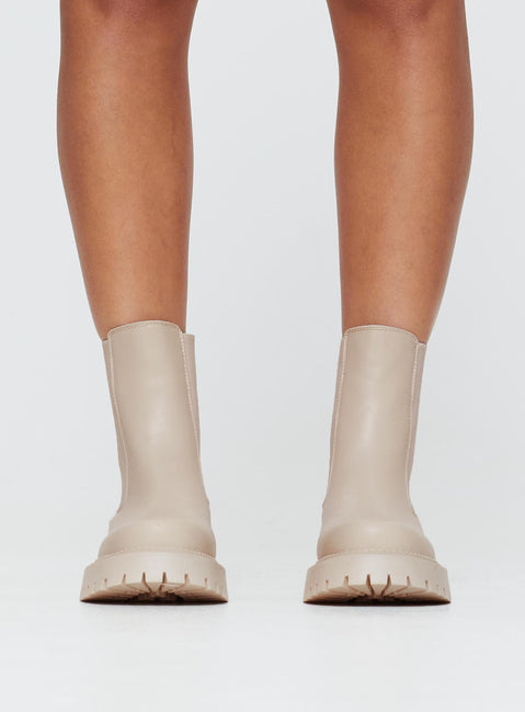 Faux leather boots Rounded toe, treaded sole, pull tab at back, passed footbed