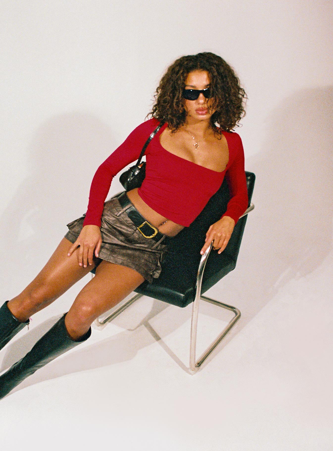   side view of model wearing Princess Polly Domenic Faux Leather Mini Skirt Washed Black Tall Mini Skirts 