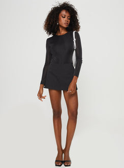 side view of model wearing Princess Polly Knighton Long Sleeve Bodysuit Black Full Sleeves Crew Neck 