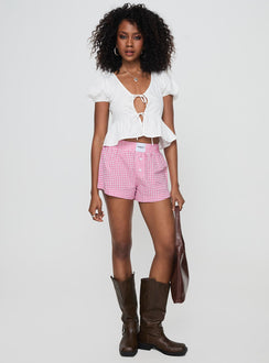 side view of model wearing Princess Polly Back To It Boxer Shorts Pink Gingham High Waisted Shorts 