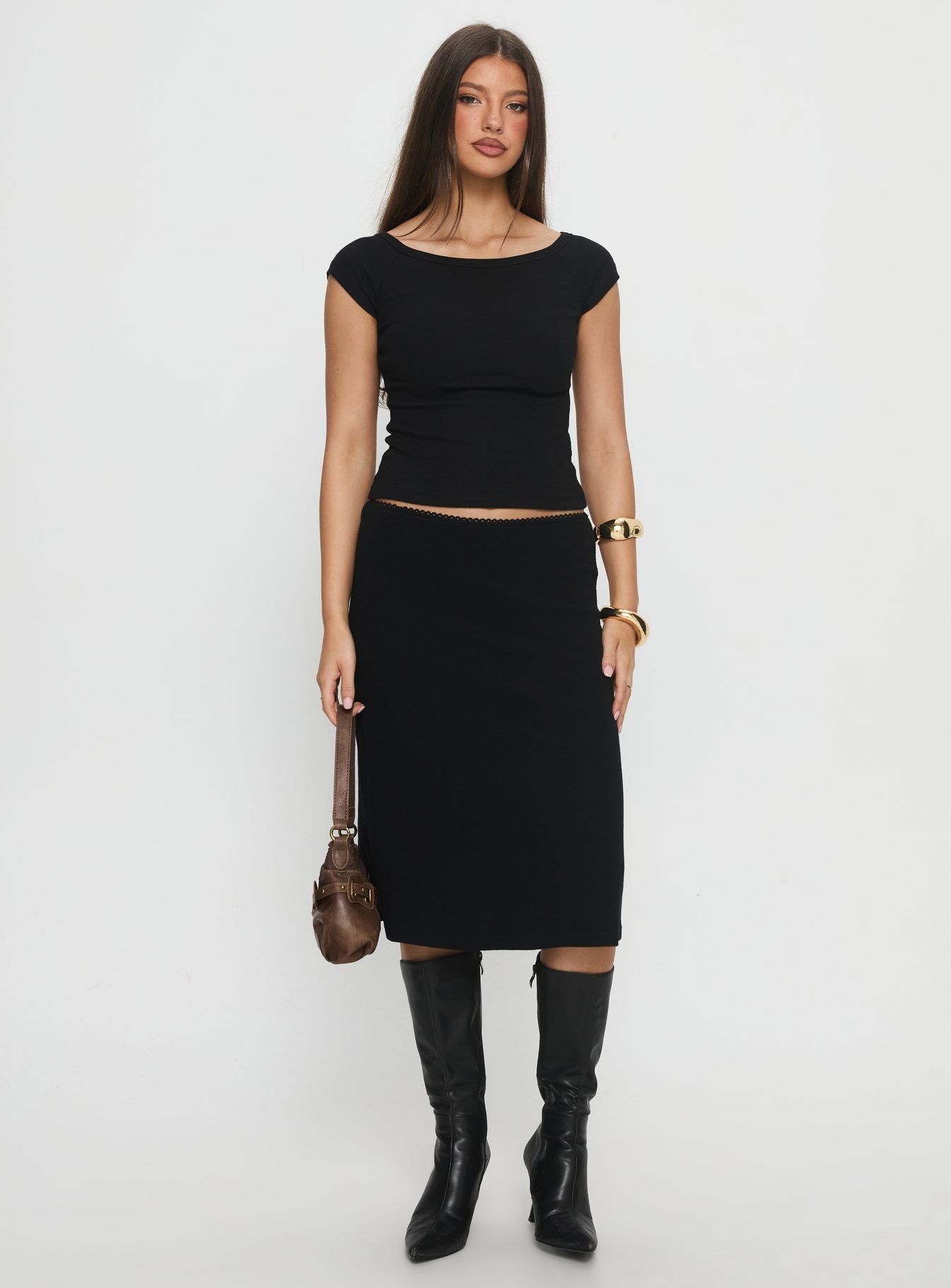   side view of model wearing Princess Polly Baseline Rib Midi Skirt Black Midi Skirts 