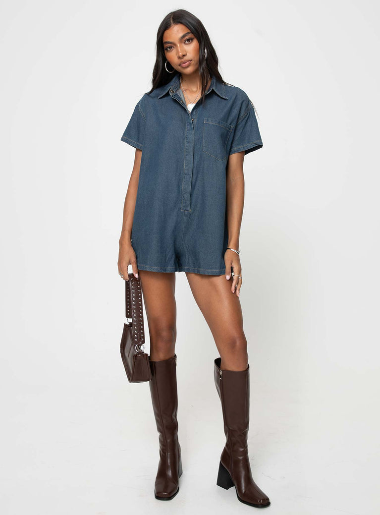 Dark wash denim romper Classic collar, button fastening down front, chest pocket, drop shoulder Non-stretch material, unlined 