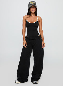 side view of model wearing Princess Polly That Effect Bodysuit Black Sleeveless 