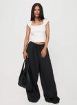 side view of model wearing Princess Polly Harbour Pant Black Petite High Waisted Pants 