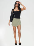 front view of model wearing Princess Polly Maceline Wrap Front Skort Green 