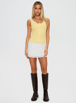 side view of model wearing Princess Polly Sole Purpose Lace Trim Top Yellow Sleeveless Scoop Neck 
