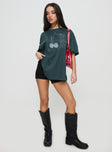 side view of model wearing Princess Polly Sour Cherry Oversized Tee Moss Green Half Sleeves Crew Neck 