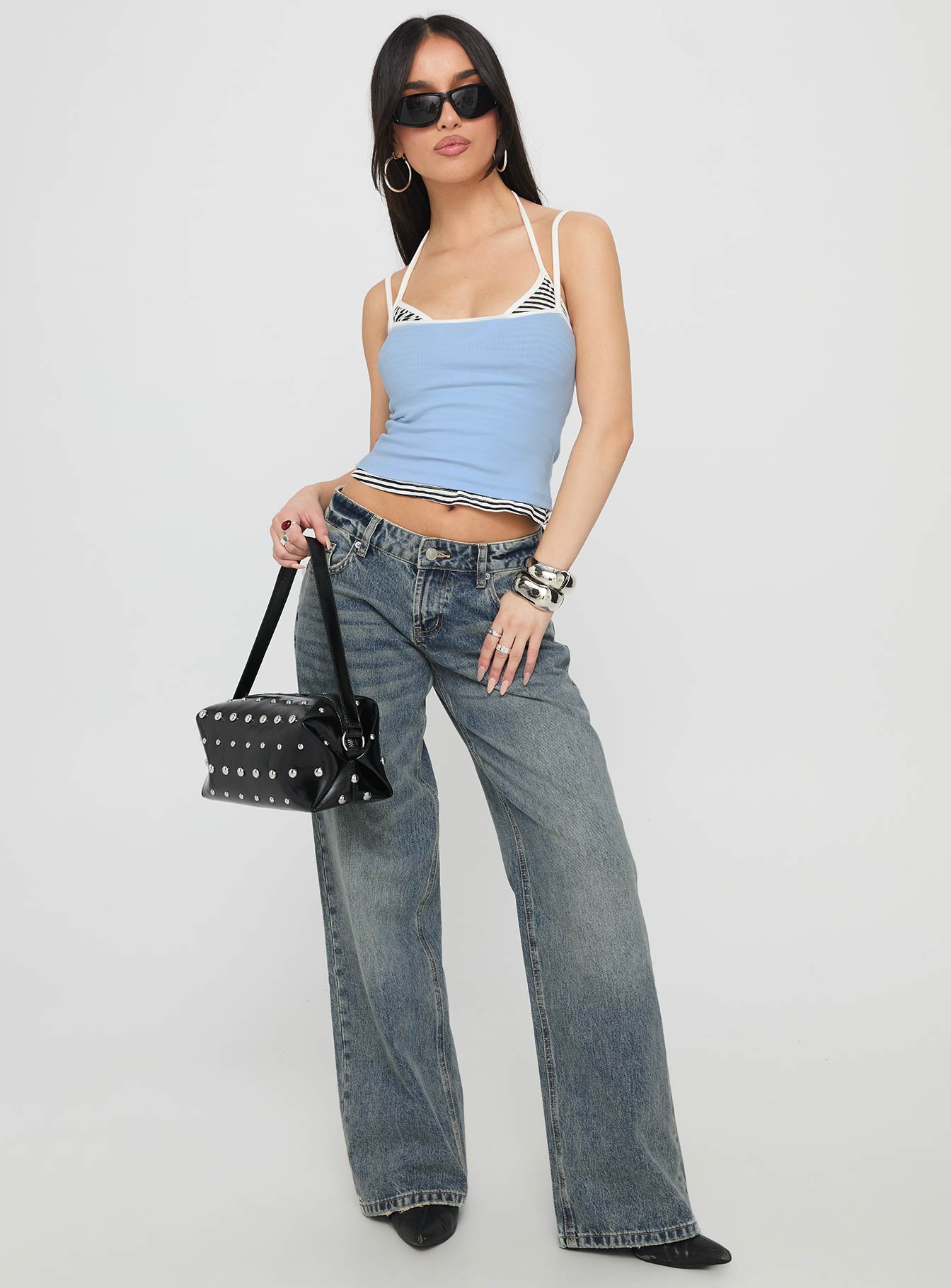side view of model wearing Princess Polly Zaralyn Low Rise Wide Leg Jeans Mid Blue Wash Low Rise Jeans 