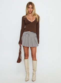   side view of model wearing Princess Polly Nikoleta Pleat Mini Skirt Brown / White Check Mini Skirts 
