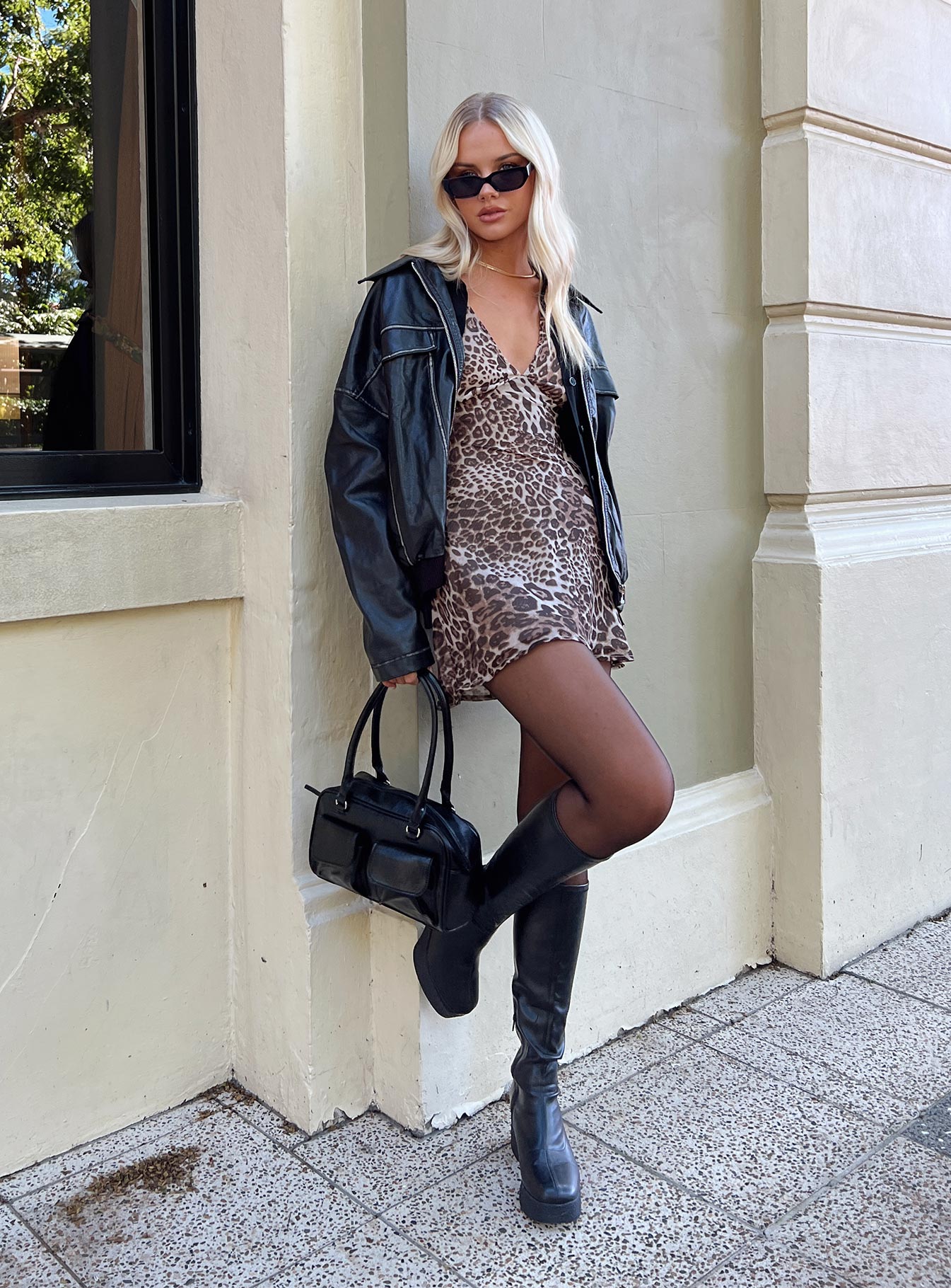 side view of model wearing Princess Polly Nellie Mini Dress Leopard Plunger 