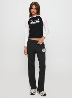 front view of model wearing Princess Polly Track Star Pants Black Low Rise Pants 