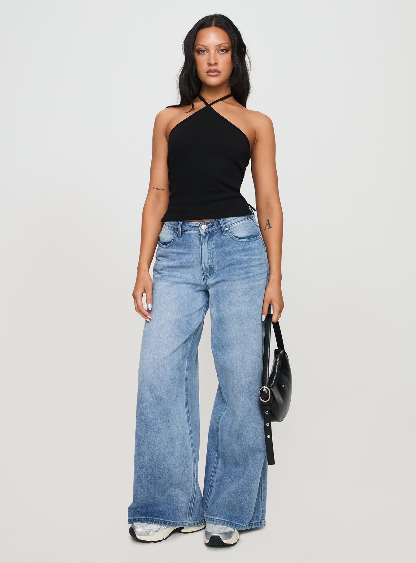 front view of model wearing Princess Polly Baseline Halter Rib Top Black Sleeveless 