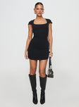 side view of model wearing Princess Polly Ravenna Mini Dress Black Scoop Neck 