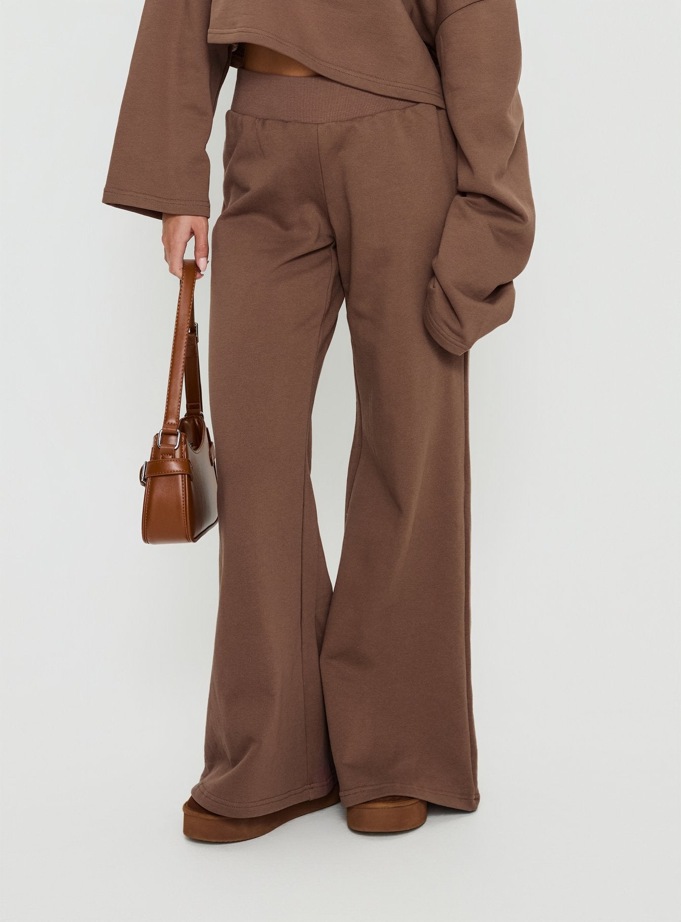 side view of model wearing Princess Polly Peaks Flared Track Pants Cocoa Mid Rise Pants 