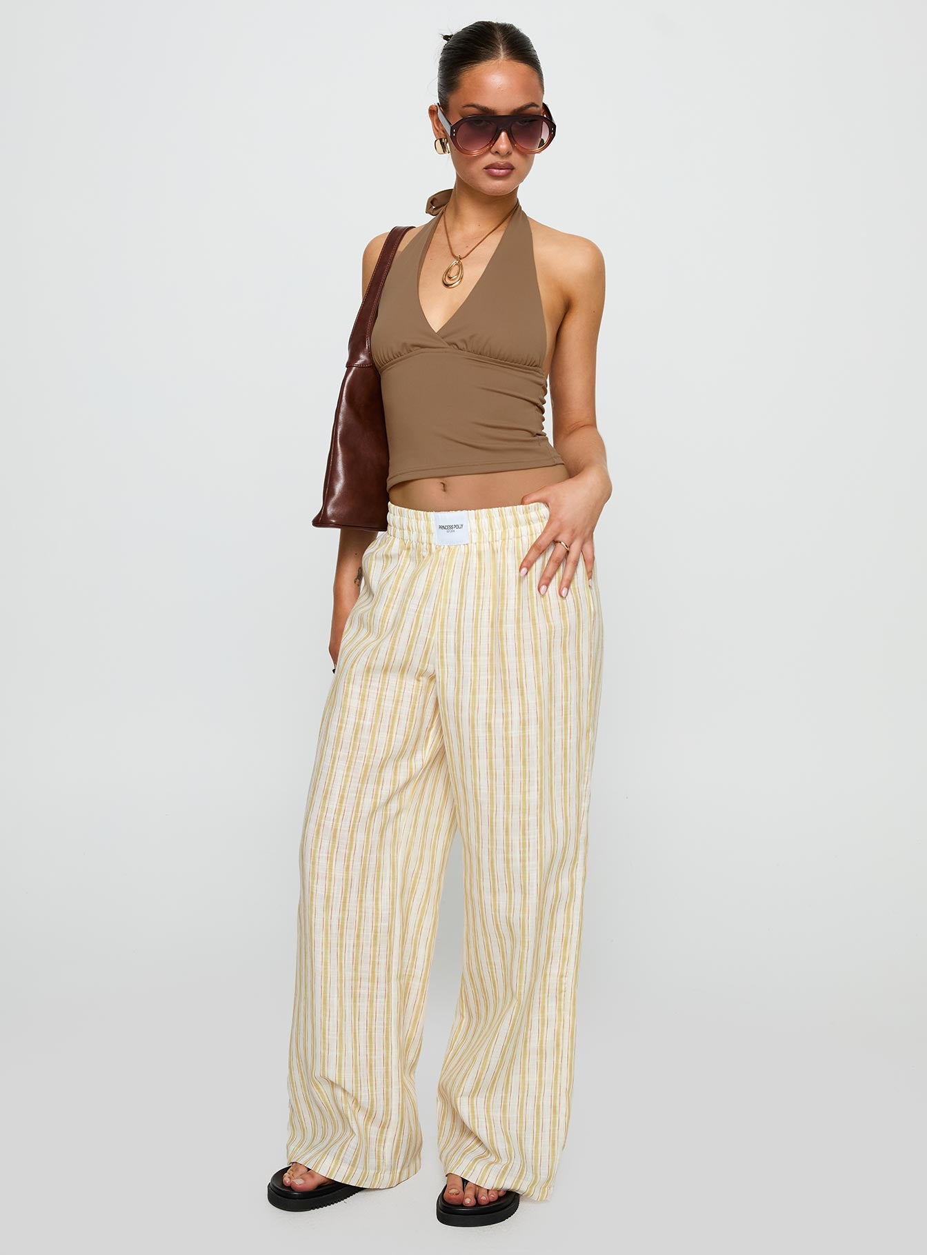 front view of model wearing Princess Polly Beach House Pants Yellow Stripe High Waisted Pants 