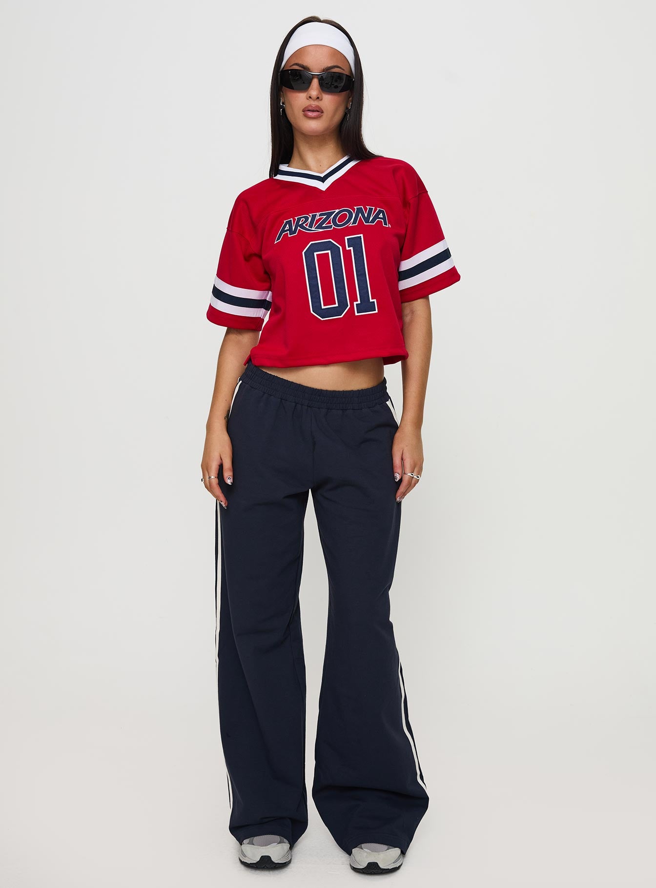 back view of model wearing Princess Polly U of A Football Jersey Red Half Sleeves V-Neck 