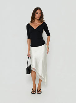 Featuring the Koletta Asymmetrical Lace Trim Satin Midi Skirt in Ivory with fitted silhouette front view of model wearing Princess Polly