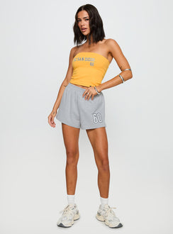 side view of model wearing Princess Polly UC San Diego Tube Top Gold Sleeveless straight 