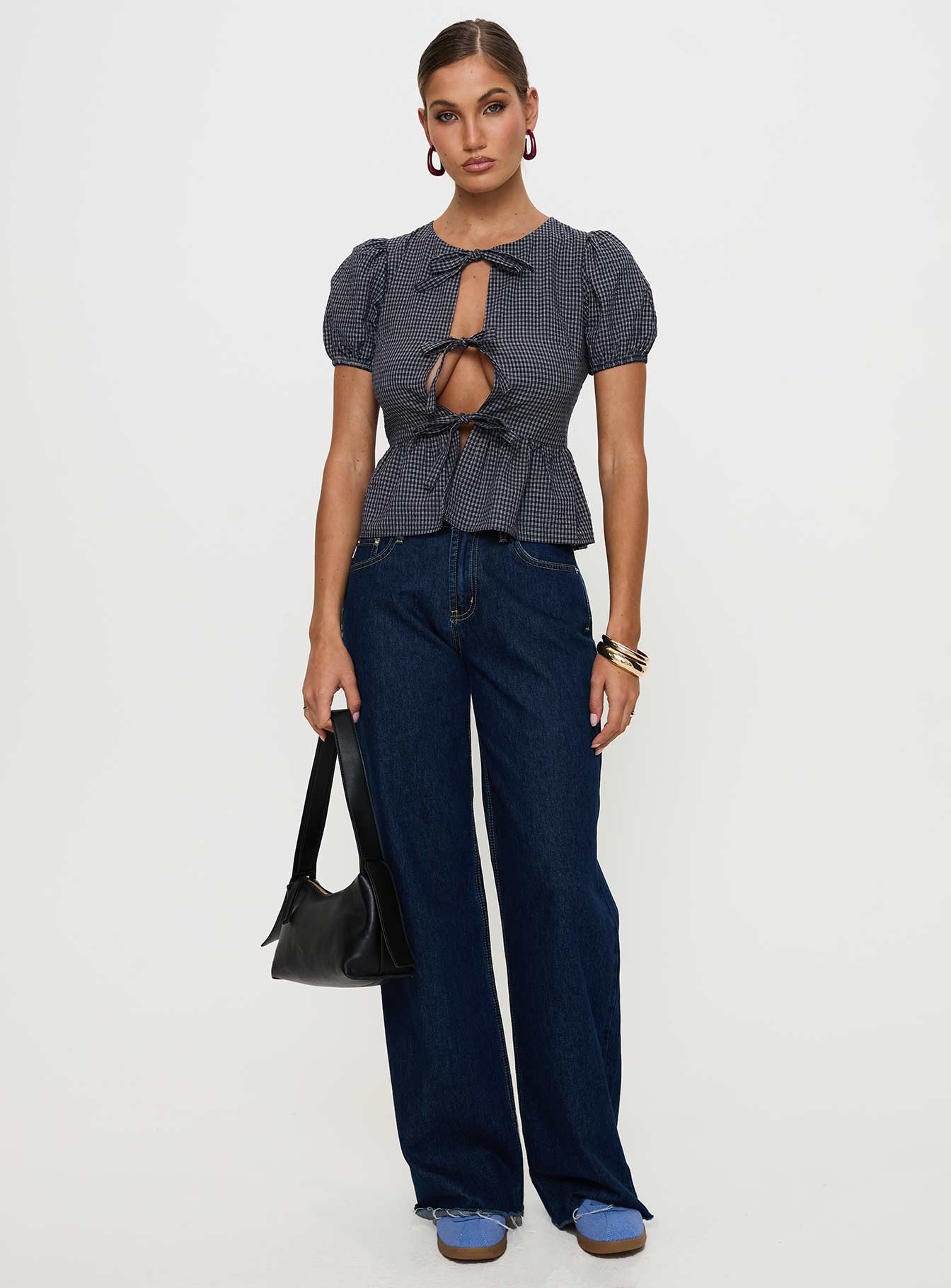 back view of model wearing Princess Polly Verah Tie Up Puff Sleeve Top Navy Check Short Sleeves Scoop Neck 