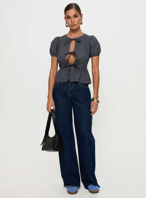 back view of model wearing Princess Polly Verah Tie Up Puff Sleeve Top Navy Check Short Sleeves Scoop Neck 