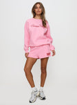 front view of model wearing Princess Polly Princess Polly Sweat Short Bubble Text Pink / Red High Waisted Shorts 