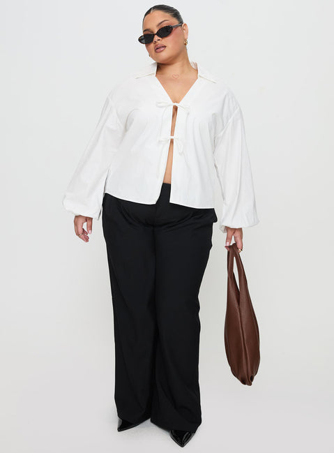 side view of model wearing Princess Polly Rinon Long Sleeve Top White Curve Full Sleeves V-Neck 