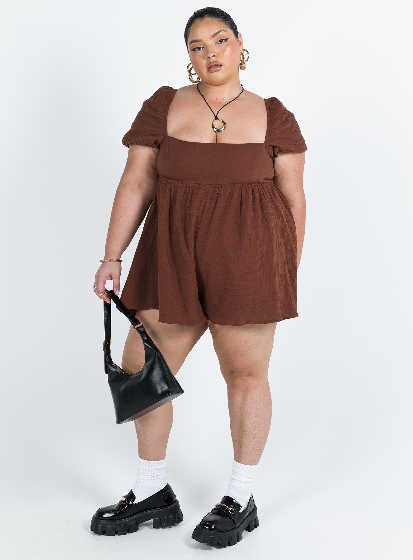 Romper Muslin material Square neckline  Elasticated puff sleeves Shirred back panel Invisible zip fastening at back  Relaxed leg 