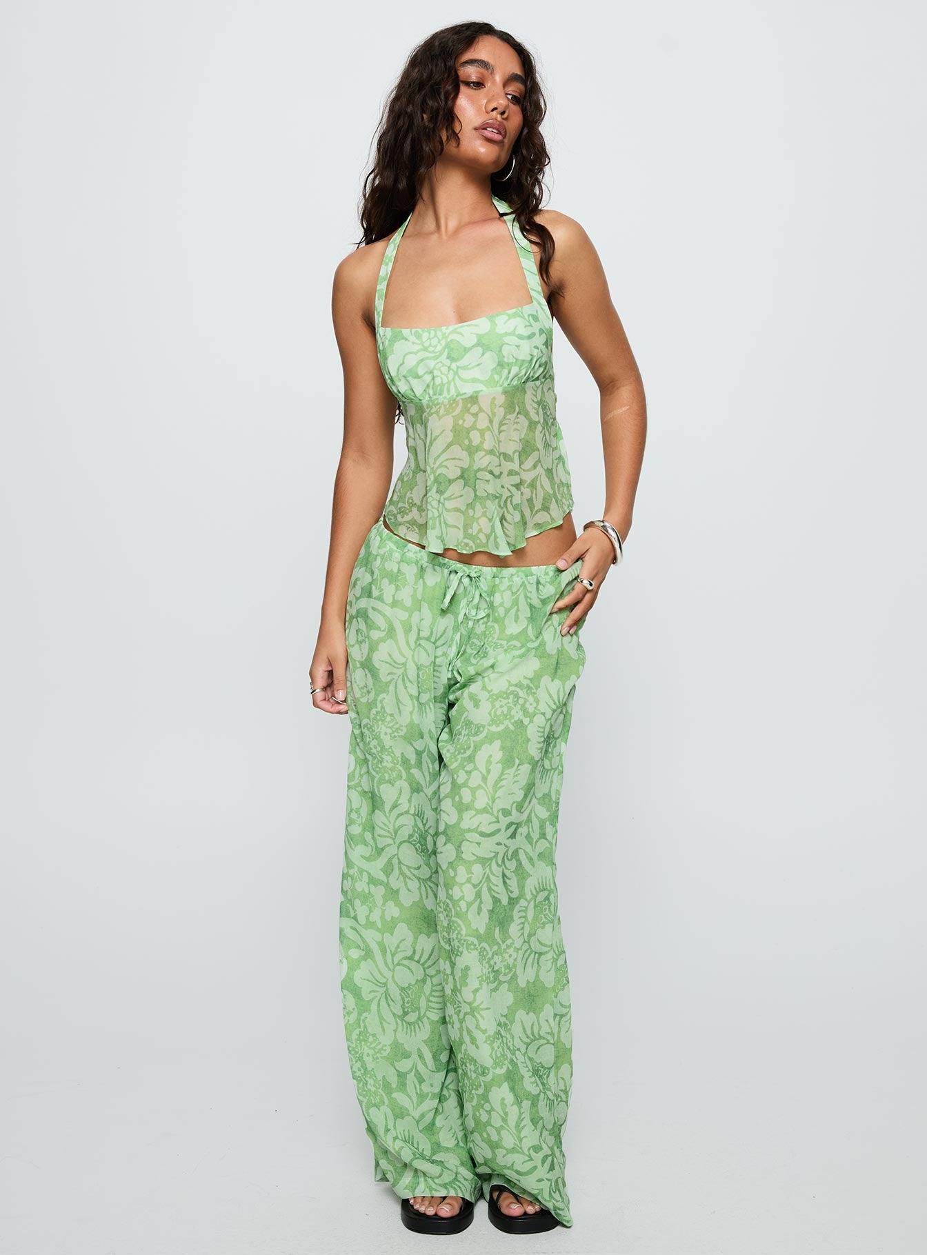 front view of model wearing Princess Polly Finesse Halter Top Green Floral Sleeveless Square Neck 