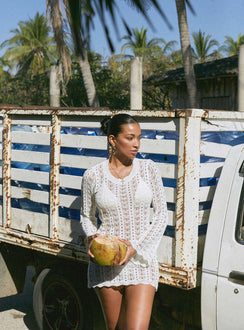 White Long sleeve mini dress Crochet style, high neckline, open back with tie fastening, flared sleeves