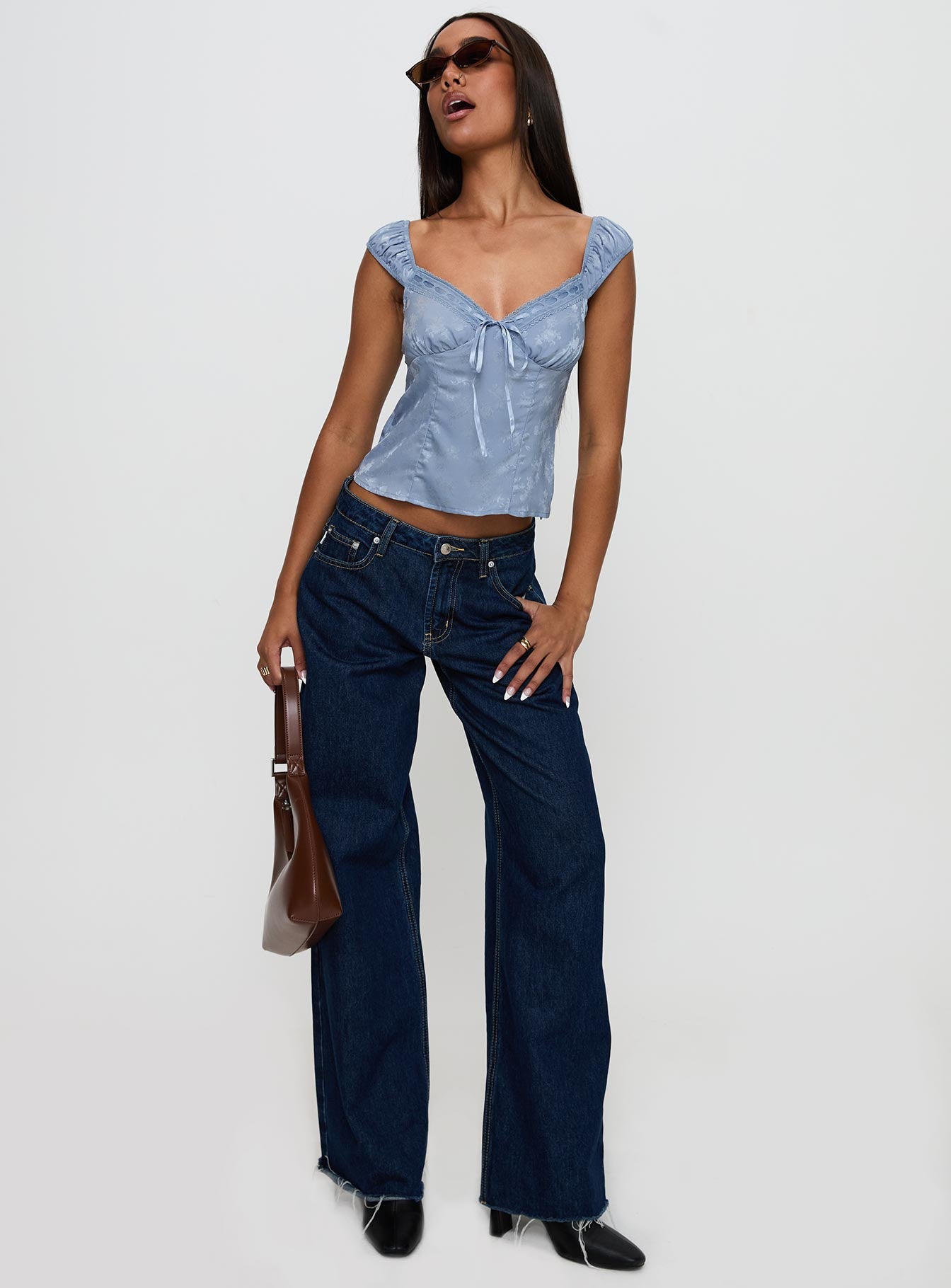 back view of model wearing Princess Polly Branwen Cap Sleeve Tie Detail Top Blue Floral Sleeveless Sweetheart 